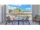 Balcony with a small round table and chairs overlooking a grassy view at 1598 Heritage Crossing Ct # 302, Reunion, FL 34747