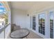This is a bright balcony with tiled flooring and white trim, accessible through glass paneled double doors at 1598 Heritage Crossing Ct # 302, Reunion, FL 34747
