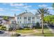 Beautiful exterior of this light blue two-story condo with a stunning palm tree at 1598 Heritage Crossing Ct # 302, Reunion, FL 34747