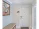 Hallway leading to Unit 302 with tiled floors, art, and bench seating at 1598 Heritage Crossing Ct # 302, Reunion, FL 34747