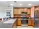 Functional kitchen featuring sleek stainless steel appliances, granite countertops, and ample storage at 1598 Heritage Crossing Ct # 302, Reunion, FL 34747