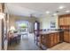 Open-concept living room with a kitchen bar, seamlessly blending relaxation and dining spaces at 1598 Heritage Crossing Ct # 302, Reunion, FL 34747