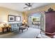 Inviting living room features a plush sofa, ceiling fan, and access to a private balcony with outdoor seating at 1598 Heritage Crossing Ct # 302, Reunion, FL 34747