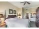 Comfortable main bedroom boasts a king-size bed and an ensuite bathroom with modern fixtures at 1598 Heritage Crossing Ct # 302, Reunion, FL 34747