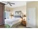 This airy bedroom has a king-size bed, armoire, and french doors leading to a private balcony at 1598 Heritage Crossing Ct # 302, Reunion, FL 34747