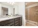Bathroom featuring a double vanity, granite countertop and tiled walk-in shower at 1639 Lima W Ave, Kissimmee, FL 34747