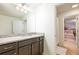 Bathroom with granite countertops, dark wood cabinets, tile floors, and decorative light fixture at 1639 Lima W Ave, Kissimmee, FL 34747