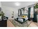 Beautifully decorated bedroom with a king-size bed, stylish wallpaper, and ample natural light at 1639 Lima W Ave, Kissimmee, FL 34747