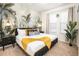 Stylish bedroom with a tropical mural, soft lighting, and cozy decor at 1639 Lima W Ave, Kissimmee, FL 34747