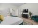 Comfortable bedroom featuring a stylish accent chair, TV, and access to the ensuite bathroom at 1639 Lima W Ave, Kissimmee, FL 34747