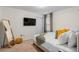 Well-lit bedroom with soft carpet, mirror, and TV at 1639 Lima W Ave, Kissimmee, FL 34747