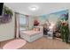 Cute bedroom featuring a castle mural, carpet, and fairy decor at 1639 Lima W Ave, Kissimmee, FL 34747
