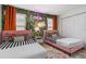 Unique bedroom design featuring two pink twin beds, accent wall, colorful rug and ample closet space at 1639 Lima W Ave, Kissimmee, FL 34747
