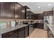 Stylish kitchen with stainless steel appliances, granite countertops, and dark brown cabinets at 1639 Lima W Ave, Kissimmee, FL 34747