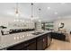 Open-concept kitchen featuring a large island with a sink and stainless steel appliances at 1639 Lima W Ave, Kissimmee, FL 34747