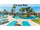 Community lazy river with lush landscaping, palm trees, and lounge chairs for relaxation at 1639 Lima W Ave, Kissimmee, FL 34747