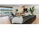 Bright living room with comfortable seating, a large TV, and a view of the pool and lake at 1639 Lima W Ave, Kissimmee, FL 34747