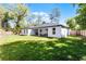 Well-maintained backyard with lush green grass, a privacy fence, and a covered patio at 1806 Paloma Ave, Sanford, FL 32771