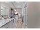 Bright bathroom featuring a granite countertop vanity, walk-in shower, and neutral tones throughout at 1806 Paloma Ave, Sanford, FL 32771