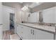 Well-lit bathroom with a double vanity featuring granite countertops, modern fixtures, and ample storage at 1806 Paloma Ave, Sanford, FL 32771