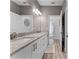 Bright bathroom features a granite countertop, double sinks, and a large mirror at 1806 Paloma Ave, Sanford, FL 32771