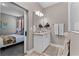 Stylish bathroom with granite countertop vanity, modern lighting, and a glimpse into the bedroom at 1806 Paloma Ave, Sanford, FL 32771