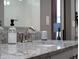 Close-up of a bathroom vanity with granite countertop and modern fixtures, complemented by soft lighting at 1806 Paloma Ave, Sanford, FL 32771