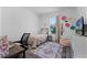 Cozy bedroom featuring a comfortable bed, desk, window, and tasteful decor for a serene atmosphere at 1806 Paloma Ave, Sanford, FL 32771