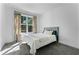 A charming bedroom featuring a comfortable bed, carpeted floors, and a sunlit window at 1806 Paloma Ave, Sanford, FL 32771