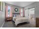 Serene bedroom with soft colors, comfortable bedding, and an en-suite bathroom with a sliding barn door at 1806 Paloma Ave, Sanford, FL 32771