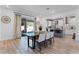 Bright dining room features a modern table, chairs, and a sliding door to the outdoor patio at 1806 Paloma Ave, Sanford, FL 32771