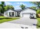 Charming single-Gathering home features a landscaped front yard, golf cart, and an attached two-car garage at 1806 Paloma Ave, Sanford, FL 32771