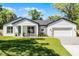Charming single-Gathering home features a landscaped front yard, stone accents, and an attached two-car garage at 1806 Paloma Ave, Sanford, FL 32771