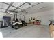 Spacious garage equipped with storage and a golf cart, providing ample room for vehicles and hobbies at 1806 Paloma Ave, Sanford, FL 32771