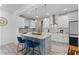 Modern kitchen boasts an island, stainless steel appliances, granite countertops, and ample cabinet space at 1806 Paloma Ave, Sanford, FL 32771