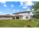 Large backyard with lush green grass and a covered patio, perfect for outdoor entertaining at 2011 Soaring Oak Way, Winter Park, FL 32792