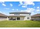 Expansive backyard with a covered patio and ample space for activities and relaxation at 2011 Soaring Oak Way, Winter Park, FL 32792