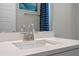 Modern bathroom sink with brushed nickel faucet, white countertop, and decorative mirror at 2011 Soaring Oak Way, Winter Park, FL 32792