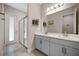 Bright bathroom with double sink vanity, glass enclosed shower, and tiled floors at 2011 Soaring Oak Way, Winter Park, FL 32792