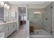 Bright bathroom featuring a glass-enclosed shower, double vanity, and access to the bedroom at 2011 Soaring Oak Way, Winter Park, FL 32792