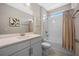 Bright bathroom featuring a vanity with quartz countertop, integrated sink, framed mirror and a shower with a tub and nice tile surround at 2011 Soaring Oak Way, Winter Park, FL 32792