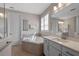 Bright bathroom featuring soaking tub, white cabinets, decorative towel, and tiled flooring at 2011 Soaring Oak Way, Winter Park, FL 32792