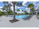 Resort-style community pool with stylish lounge chairs and palm trees, creating a relaxing atmosphere at 2011 Soaring Oak Way, Winter Park, FL 32792