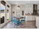 Sunny kitchen nook with a wooden table, colorful chairs, and a view of the backyard at 2011 Soaring Oak Way, Winter Park, FL 32792