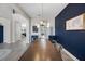 Open view of the dining room with modern decor, light wood floors, and an accent wall at 2011 Soaring Oak Way, Winter Park, FL 32792