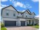 Charming two-story home featuring a three-car garage, brick driveway and beautifully landscaped yard at 2011 Soaring Oak Way, Winter Park, FL 32792