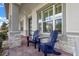 Covered front porch featuring stone accents, dark trim, and two Adirondack chairs at 2011 Soaring Oak Way, Winter Park, FL 32792