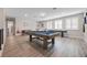 Open game room with a pool table, comfortable lighting, and space for entertainment at 2011 Soaring Oak Way, Winter Park, FL 32792