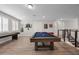 Bright game room with a pool table, shuffleboard, and plenty of space for fun and games at 2011 Soaring Oak Way, Winter Park, FL 32792