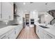Modern kitchen with white cabinetry, stainless steel appliances, and wood-look flooring at 2011 Soaring Oak Way, Winter Park, FL 32792